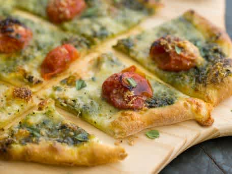Homemade Pizza with Mozzarella, Cherry Tomatoes and Pesto