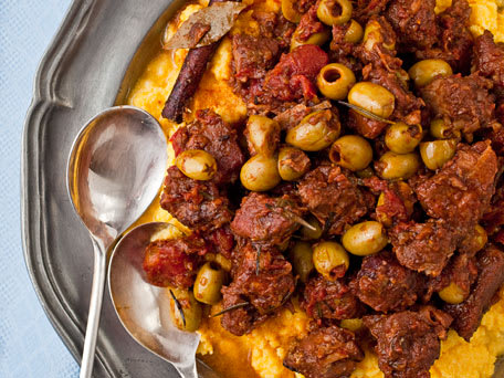 Braised Pork Shoulder with Tomatoes, Cinnamon, and Olives Over Polenta