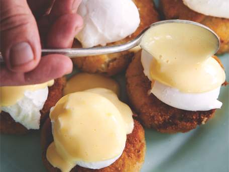 Poached Eggs & Satsuma Hollandaise over Crab Cakes