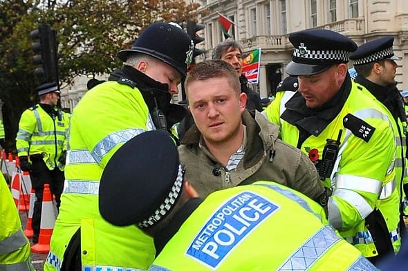 Stephen Lennon is arrested by police at a Remembrance Day protest on 