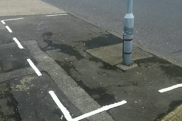 Dim-witted council workers paint parking space around lamp post