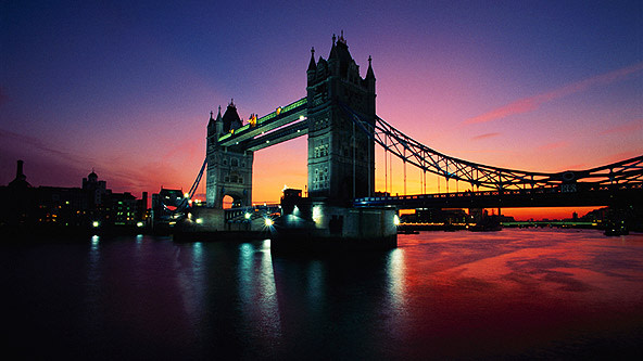 The iconic Tower Bridge in London England stands over the Thames River at 
