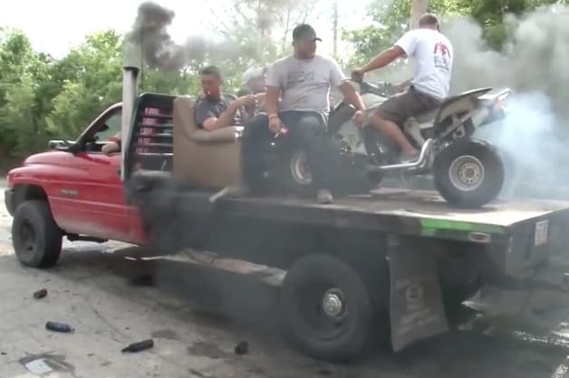 photo of Video: Coal-rolling Ram dually does tandem beer-shooting burnout with ATV in bed image