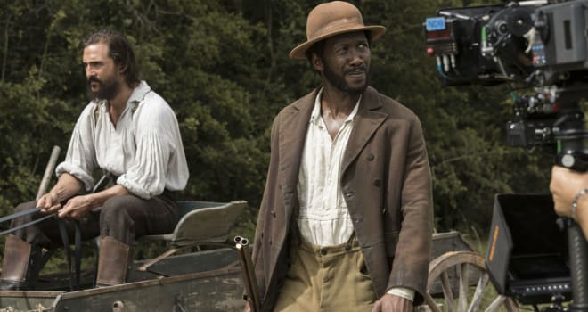While driving the horse wagon down a country road, Newt (Matthew McConaughey) tries to stop Moses (Mahershala Ali) in FREE STATE OF JONES