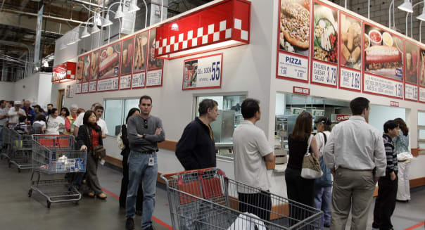 Earns Costco Wholesale (A Costco warehouse customers wait in a long ...