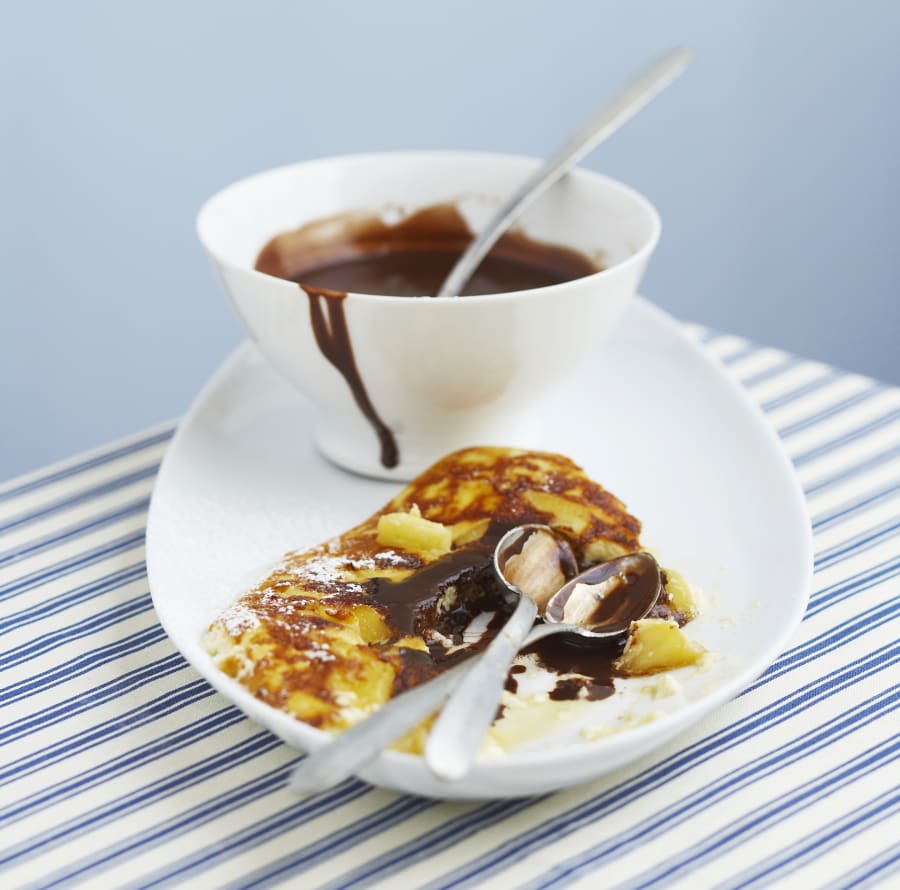 Omelette with chocolate sauce on plate, close-up