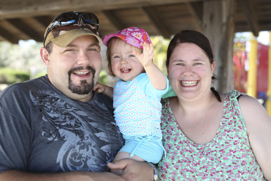 Father and mother with her little daughter