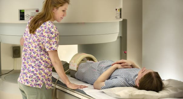 Nurse attending patient in open MRI Scanner