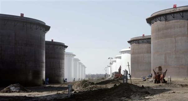 This March 13, 2012 photo shows older and newly constructed 250,000 barrel capacity oil storage tanks at the SemCrude tank farm north of Cushing, Okla. For the past seven weeks, the United States has been producing and importing an average of 1 million more barrels of oil every day than it is consuming. That extra crude is flowing into storage tanks, especially at the country's main trading hub in Cushing, pushing U.S. supplies to their highest point in at least 80 years, the Energy Department reported Wednesday, Feb. 25, 2015. (AP Photo/Tulsa World, Michael Wyke) KOTV OUT; KJRH OUT; KTUL OUT; KOKI OUT; KQCW OUT; KDOR OUT; TULSA OUT; TULSA ONLINE OUT