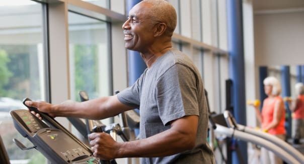 African man working out on elliptical machine