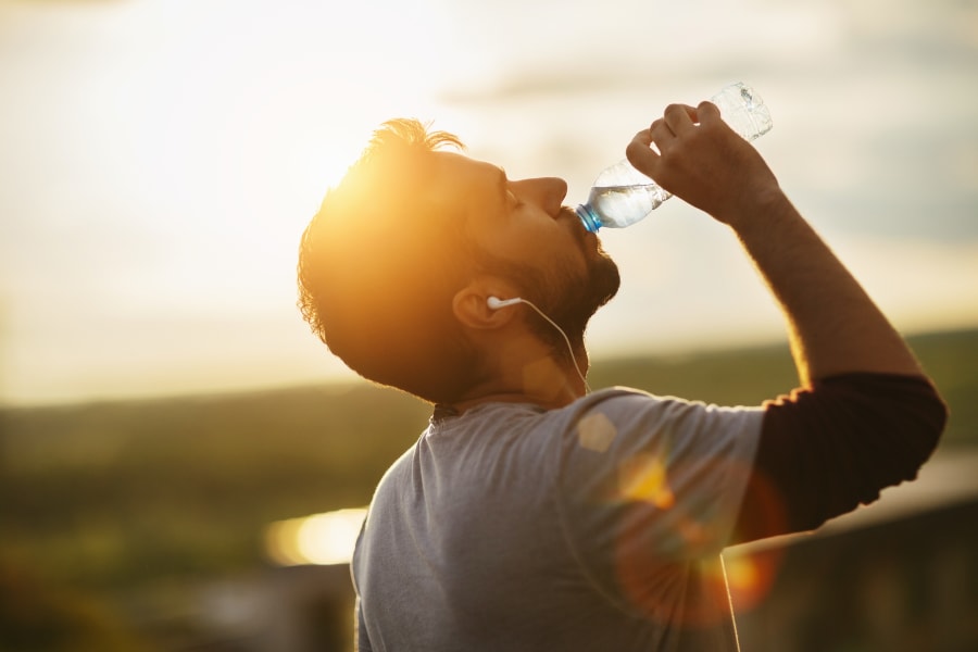 Photo of a young man drinking water