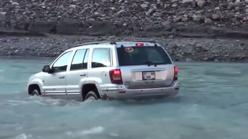 Jeep driver nearly gets washed away by fast moving river