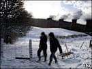 Sledgers in the snow overlooking Ironbridge Power Station, Shropshire 