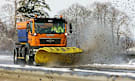 A snow plough clears snow from a Kent motorway