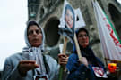Women, holding a picture of Neda Agha Soltan, the young Iranian protester bled to death on the streets of Tehran , are seen during a candlelight vigil to honour the victims of violence in Iran and to oppose the results of the Presidential elections in Iran , in Berlin on Thursday, June 25, 2009.