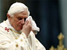 Pope Benedict XVI uses a handkerchief during a canonization ceremony at the Vatican in this Oct. 11, 2009 file photo. A woman jumped barriers and knocked down the pope during a Christmas Eve mass at the Vatican Dec. 24, 2009. He was not hurt.