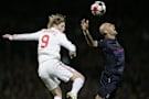 Liverpool's Fernando Torres, left, challenges for the ball with Lyon's Cris