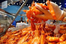 A hand scoops up prawns to sell at the Sydney Fish Markets