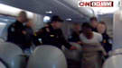 Officers take suspect into custody in Detroit, Michigan, after an attempt to destroy a Northwest Airlines flight.