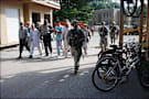 Civilian trainees and Indiana National Guardsmen walk with role-playing Afghans at Camp Atterbury training center.
