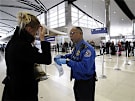 Transportation Security Administration agent Paul Marshall helps an international traveler at the Detroit Metropolitan Airport in Romulus, Mich., Dec. 26, 2009.