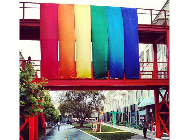 Rainbow flags above a city street