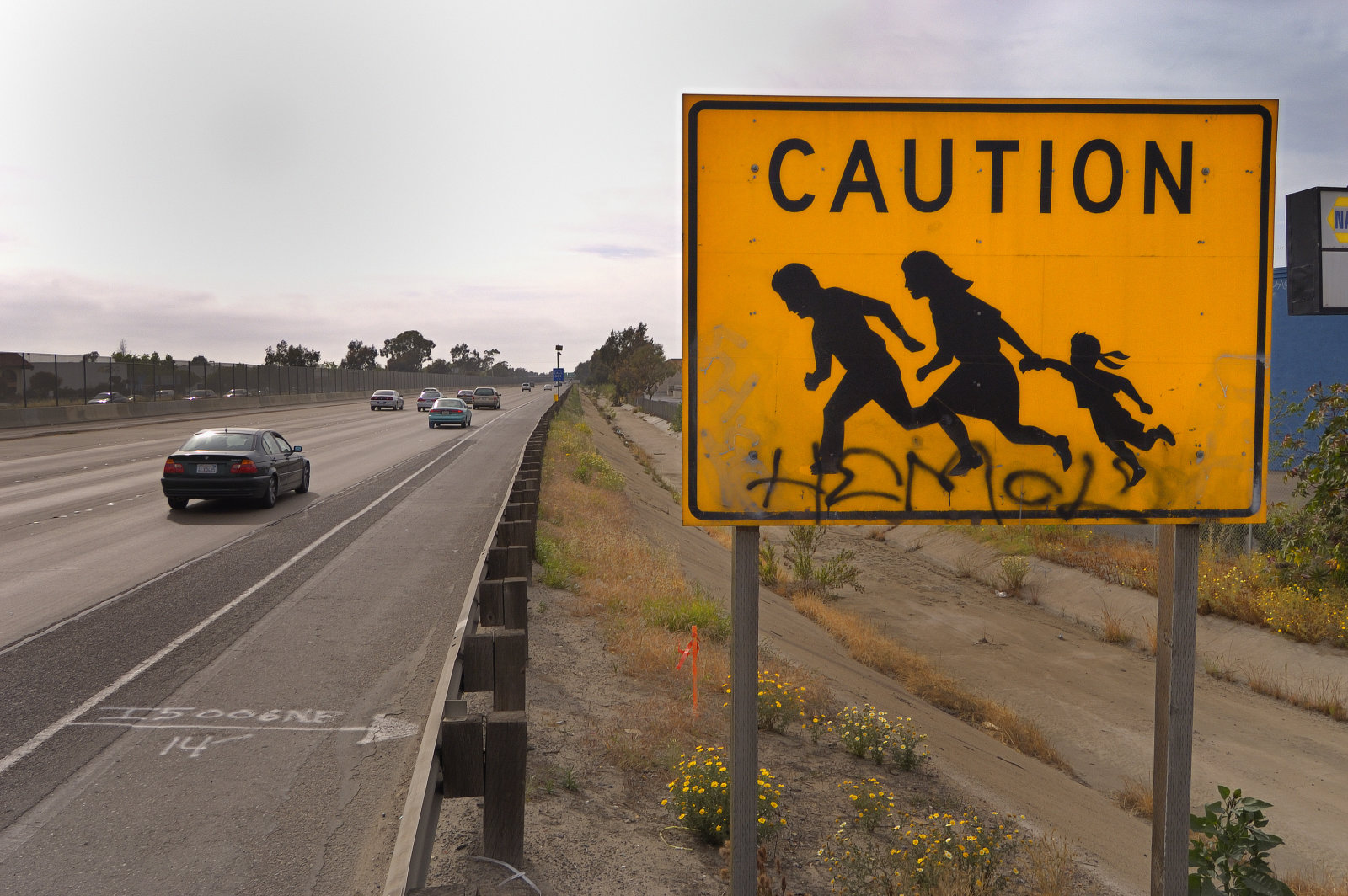A road sign, along Interstate Highway 5 near San Ysidro, California, warns motorists to watch out for migrant workers crossing the highway. According to the US Border Patrol, 1,954 people died crossing the U.S.-Mexico border illegally between the years 1998-2004. The United States office of Homeland Security has plans to expand border security between the two countries in an attempt to stem the tide of illegal immigrants entering the USA from Mexico. (Photo by Christopher Morris/Corbis via Getty Images)