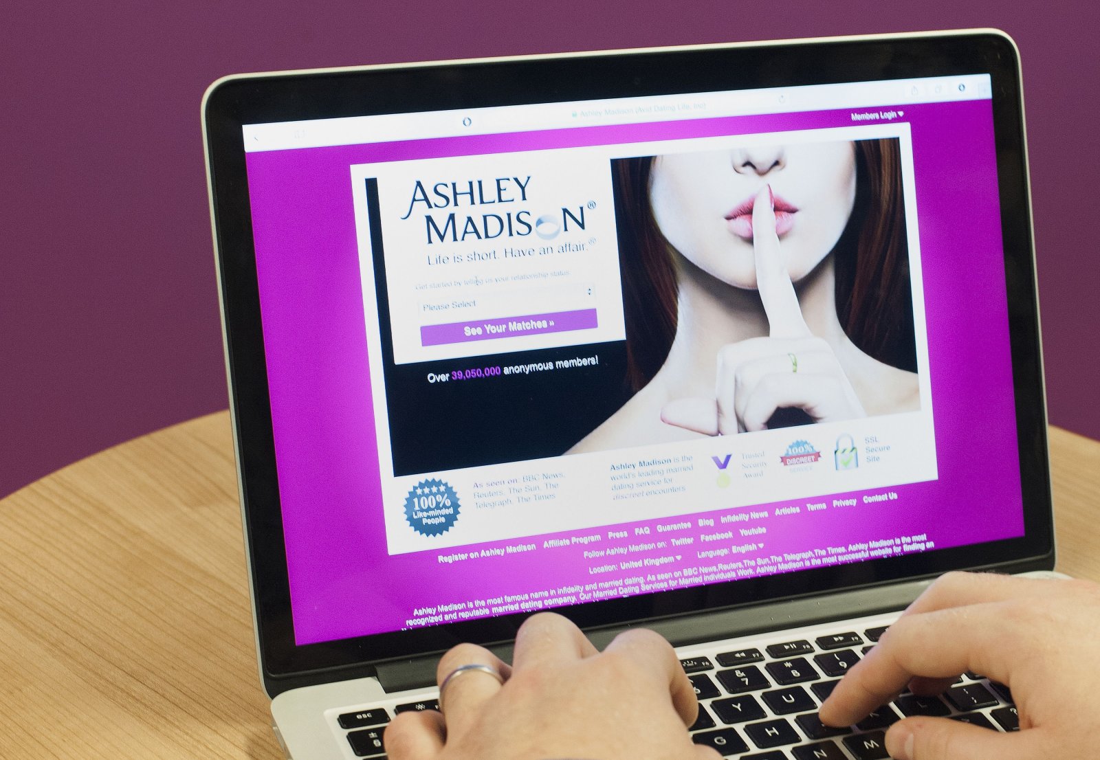 PICTURE POSED BY MODEL A man wearing a wedding ring looks at the Ashley Madison website, as a second wave of personal data alleged to have come from the adultery site has been published online by the site's hackers.