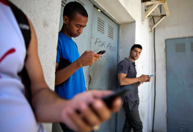 Cubans using their cellphones