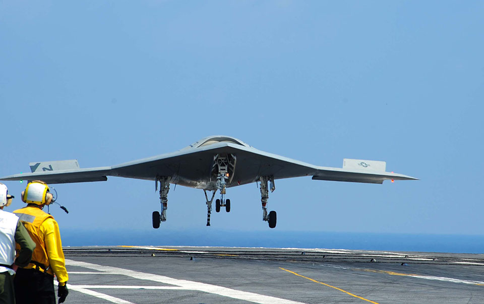 photo of Navy drone plays well with manned aircraft, caps it with a carrier landing image