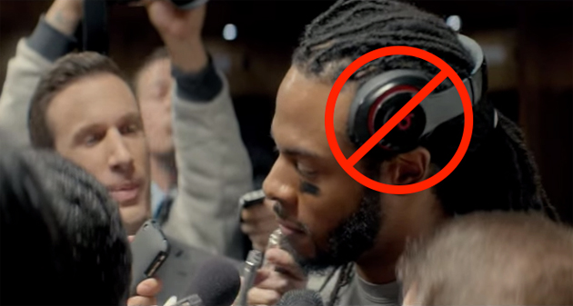 Richard Sherman wearing verboten Beats headphones in a TV ad