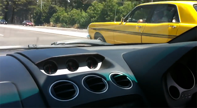 Screencap from video of a drag race between a Ford Falcon GT and Lamborghini Gallardo in Australia.