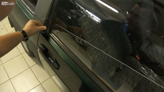 Screencap from a video showing how to open a locked car door with a piece of string.