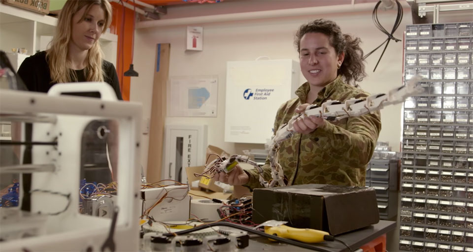 A Google X engineer holds a robot snake