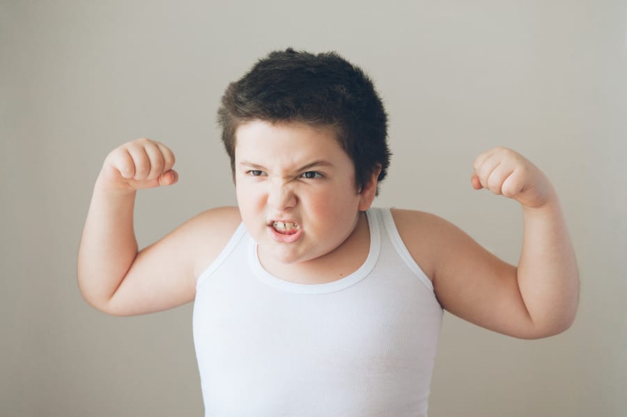 child kid showing muscles exercise  teeth