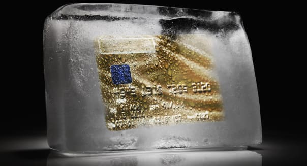 Credit card frozen inside a block of ice