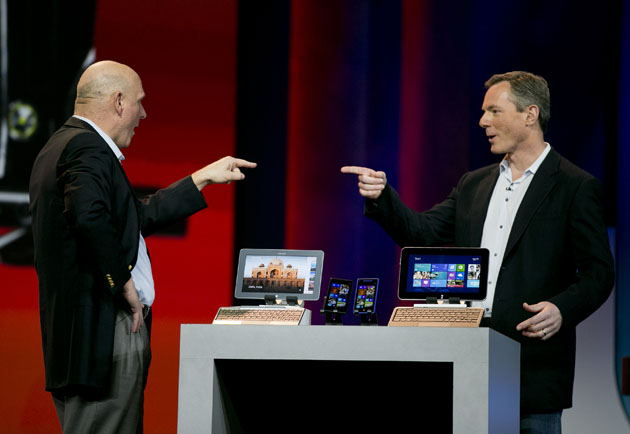 Paul Jacobs, chief executive officer of Qualcomm Inc., right, and Steve Ballmer, chief executive officer of Microsoft Corp., gesture towards each other during a keynote speech at the 2013 Consumer Electronics Show in Las Vegas, Nevada, U.S., on Monday, Jan. 7, 2013. The 2013 CES trade show, which runs until Jan. 11, is the world's largest annual innovation event that offers an array of entrepreneur focused exhibits, events and conference sessions for technology entrepreneurs. Photographer: Andrew Harrer/Bloomberg via Getty Images