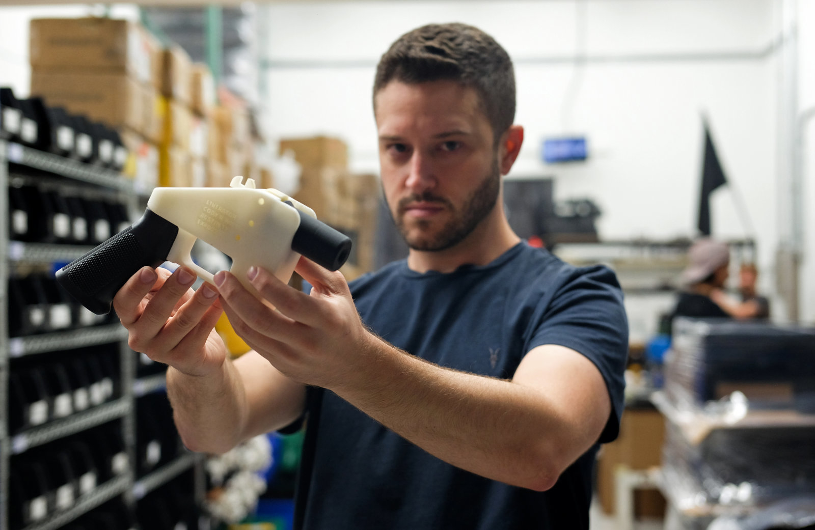 TOPSHOT - Cody Wilson, owner of Defense Distributed company, holds a 3D printed gun, called the "Liberator", in his factory in Austin, Texas on August 1, 2018. - The US "crypto-anarchist" who caused panic this week by publishing online blueprints for 3D-printed firearms said Wednesday that whatever the outcome of a legal battle, he has already succeeded in his political goal of spreading the designs far and wide. A federal court judge blocked Texan Cody Wilson's website on Tuesday, July 31, 2018, by issuing a temporary injunction. (Photo by Kelly WEST / AFP)        (Photo credit should read KELLY WEST/AFP/Getty Images)