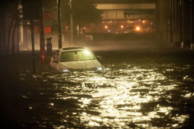 Hurricane Sandy batters the New York City skyline as the Lower Manhattan streets are inundated with flood waters from Sandy's st