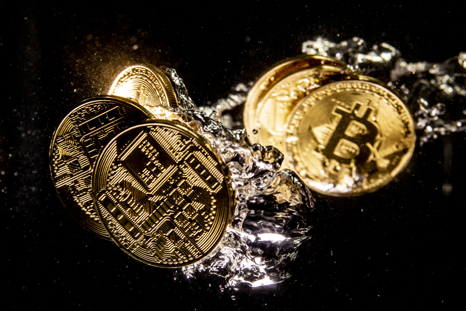 LONDON, ENGLAND - AUGUST 15: In this photo illustration a visual representation of the digital currency Bitcoin sinks into water on August 15, 2018 in London, England. Most digital currencies including Bitcoin, (BTC) Ethereum, (ETH) Ripple (XRP) and Stella (XLM) have seen a dramatic fall in their prices throughout 2018 amid a 'mass sell-off'. In December 2017 the price of BTC hit $20,000 USD but has since fallen to around $6000 USD.   (Photo Illustration by Dan Kitwood/Getty Images)