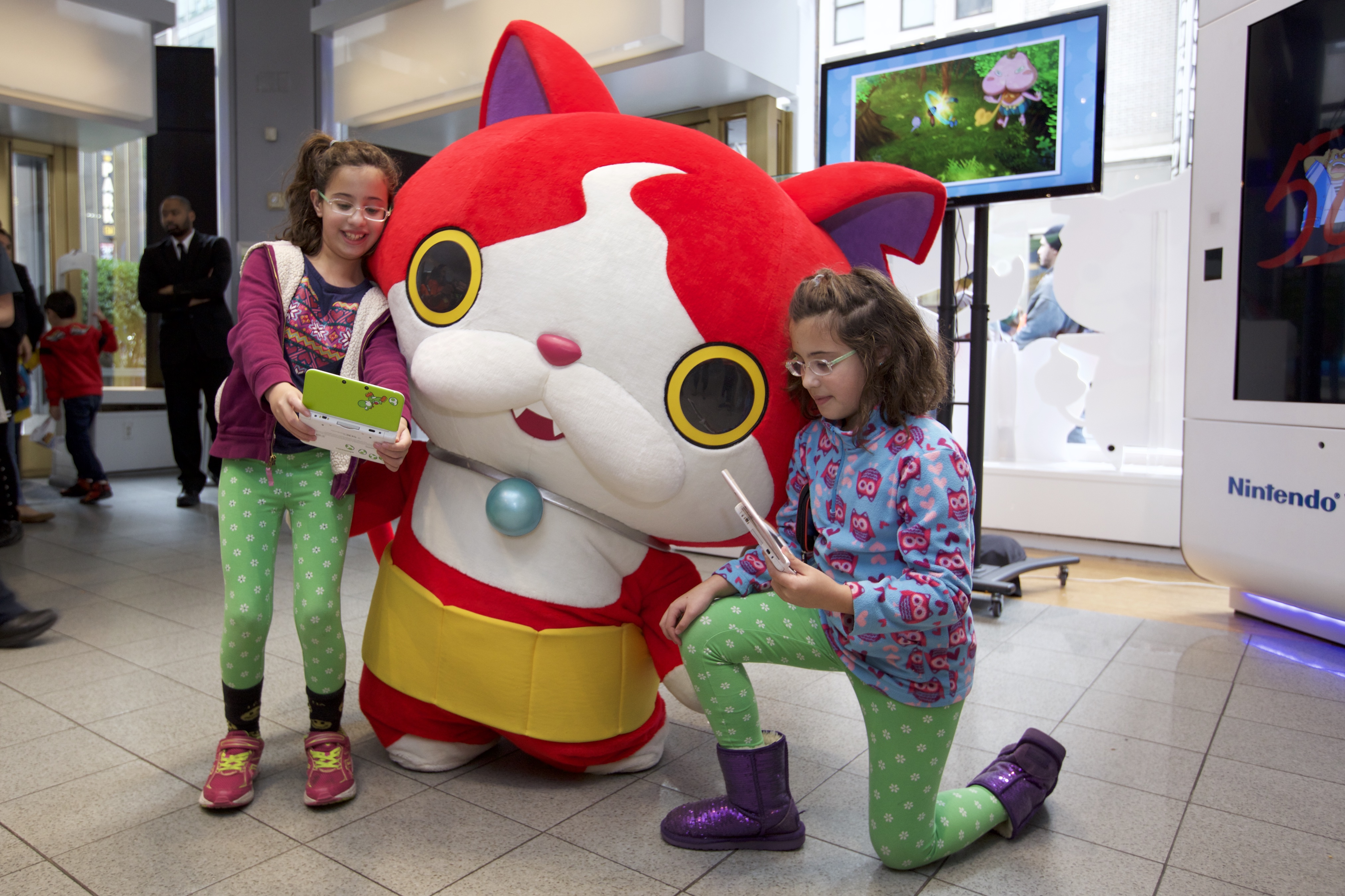 In this photo provided by Nintendo of America, fans meet and interact with YO-KAI WATCH character Jibanyan at Nintendo World in New York on Nov. 7, 2015, as part of the YO-KAI WATCH launch event. YO-KAI WATCH launched on Nov. 6, 2015 and is available exclusively for the Nintendo 3DS family of systems.