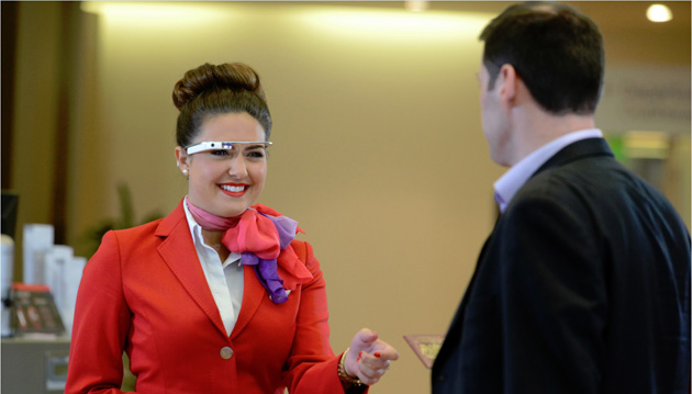 Airline staffer using Google Glass to greet a passenger