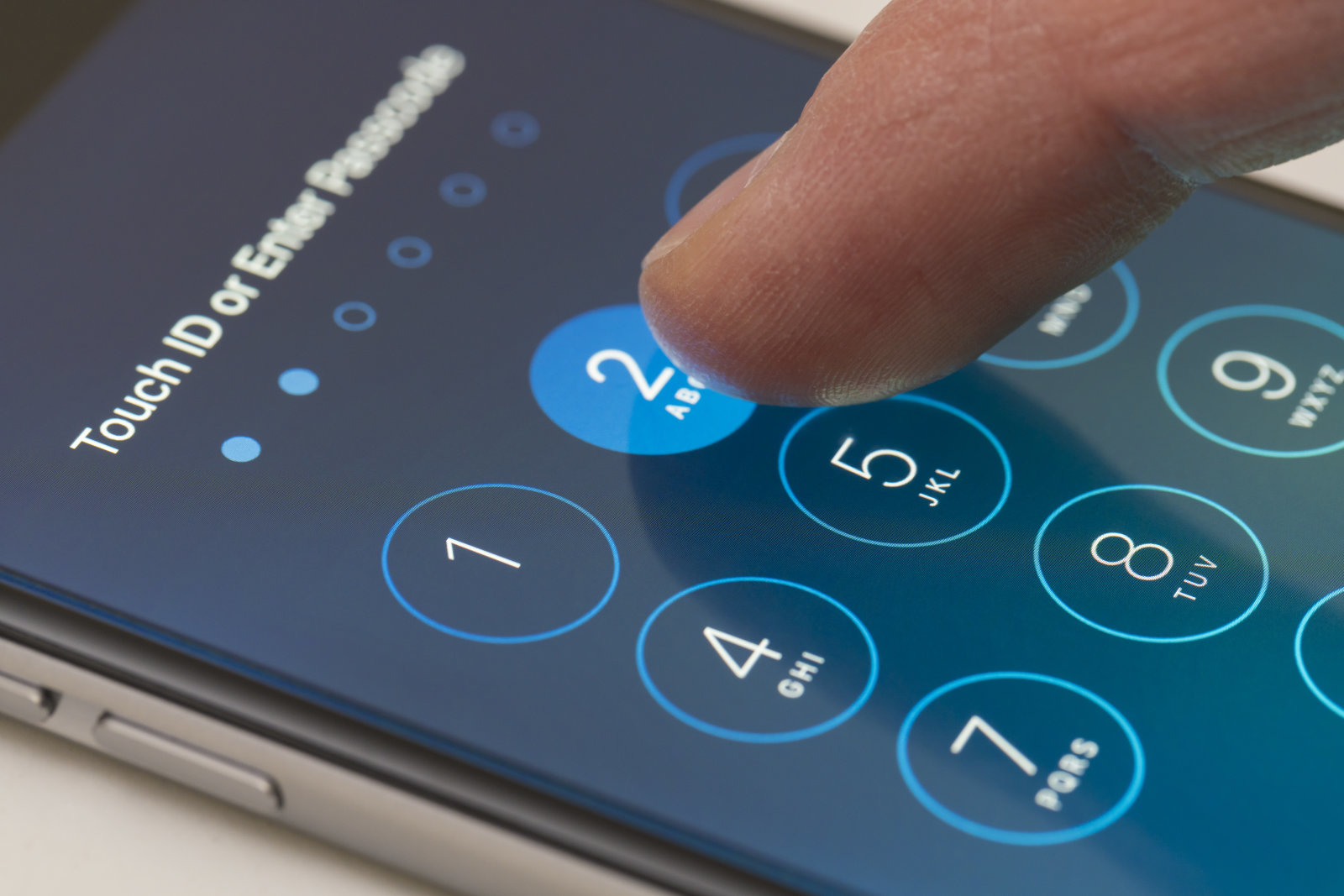 Melbourne, Australia - Sep 24, 2015: Entering passcode on an iPhone running iOS 9.  This new iOS release has six digits passcodes instead of four.