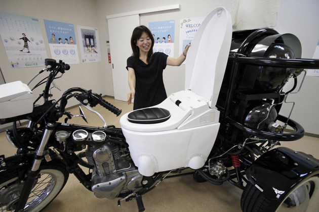 Japanese toilet maker TOTO employee Akiko Matsuyama laughs as she shows a 