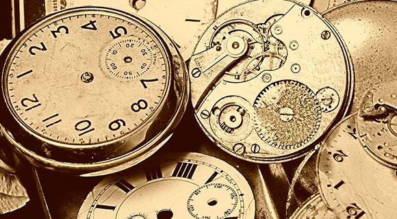 A photograph of antique timepieces and watches