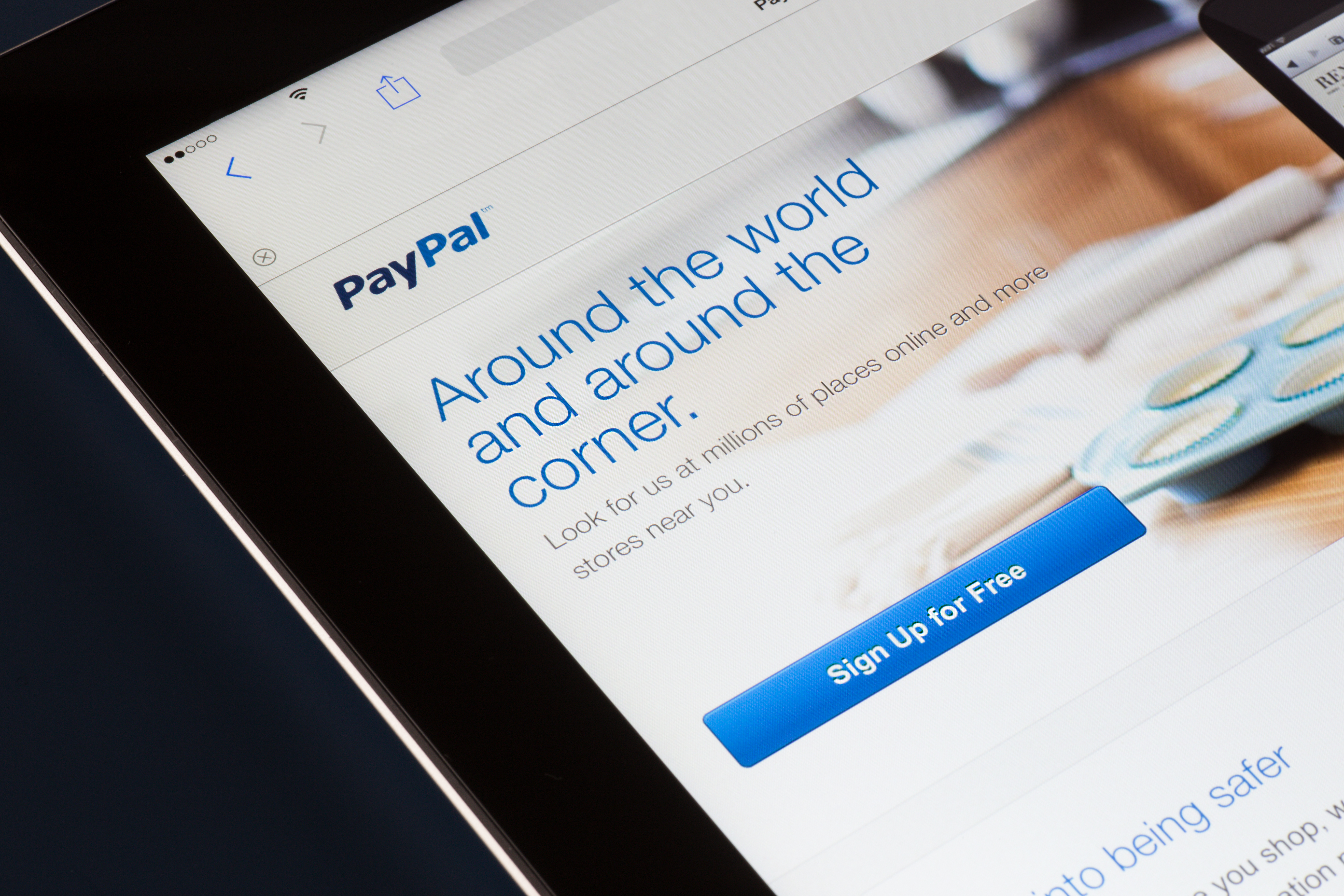 NEW YORK CITY - FEB. 3, 2014:  Paypal website displayed on tablet screen against dark background.  Established in 1999, PayPal a
