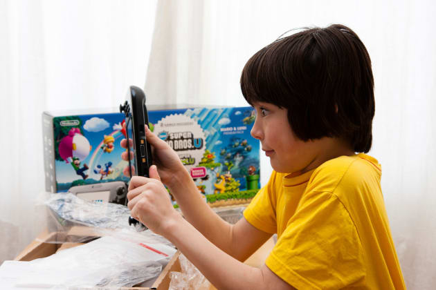 Caucasian child, tween, 10 to 12 years old, playing with Nintendo Wii U game console