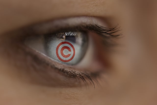 Woman looking at an Internet site with copyright sign. Symbol: protection of the copyright in the internet.