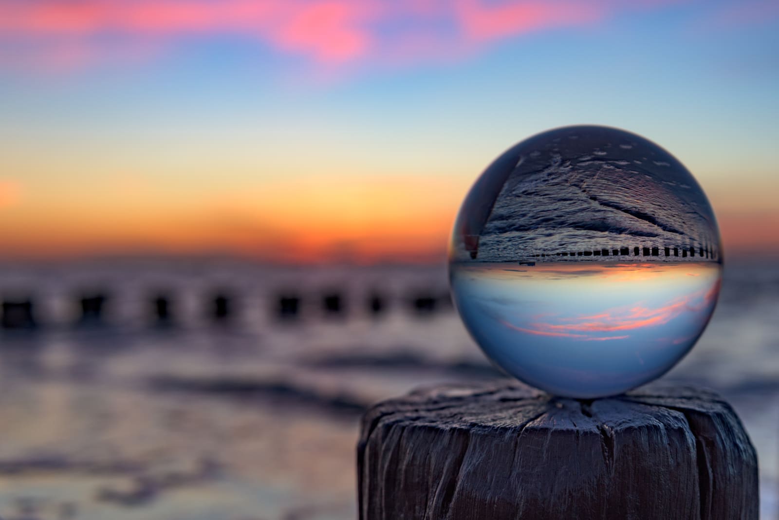Sunset with a glass globe at the beach