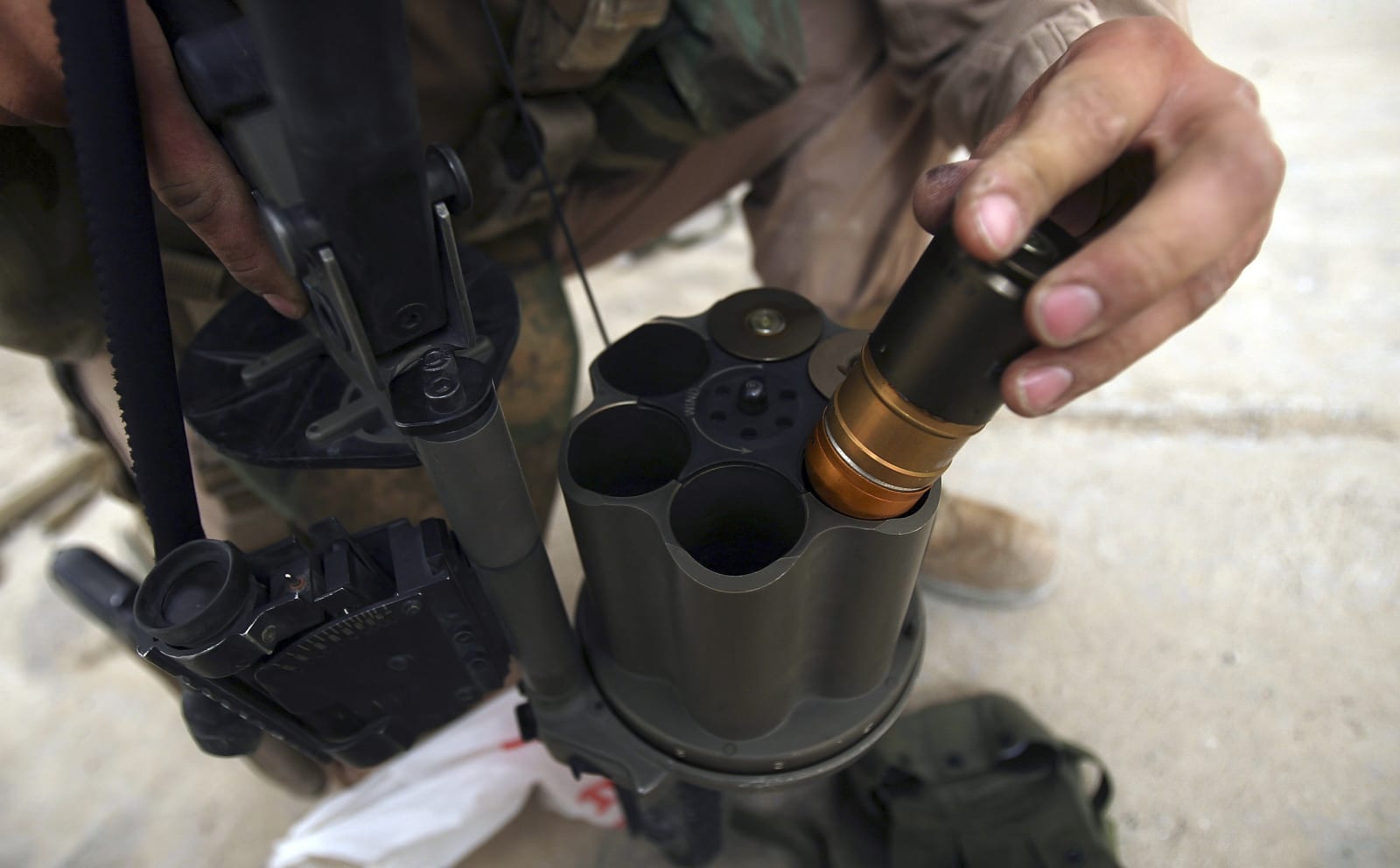 A Marine from 1st Battalion, 24th Marine Regiment loads 40 mm grenades during a training exercise at Camp Fallujah's Eagle Range